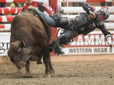 Tyler Thomson is bucked from his bull during the bull riding event at the Calgary Stampede Rodeo at the Stampede Grandstand in Calgary on Saturday, July 4, 2015.
