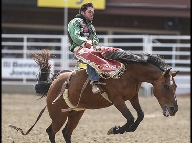 Luke Creasy is tossed about during the bareback event at the Calgary Stampede Rodeo at the Stampede Grandstand in Calgary on Saturday, July 4, 2015.
