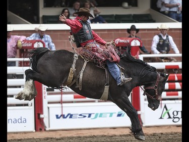 Sam Kelts holds on for the full eight during the saddle bronc event at the Calgary Stampede Rodeo at the Stampede Grandstand in Calgary on Saturday, July 4, 2015.