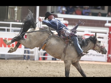 Lane Link holds on during the novice saddle bronc and bareback event at the Calgary Stampede Rodeo at the Stampede Grandstand in Calgary on Saturday, July 4, 2015.