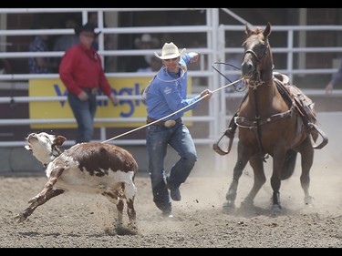 Hunter Herrin chases after his calf during the tie-down roping event at the Calgary Stampede Rodeo at the Stampede Grandstand in Calgary on Saturday, July 4, 2015.