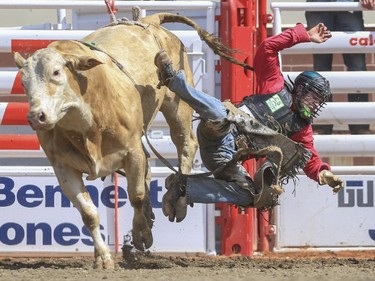 Dakota Buttar hops off Moe and finishes in fifth place during day three bull riding action at the 2015 Calgary Stampede, on July 5, 2015. -