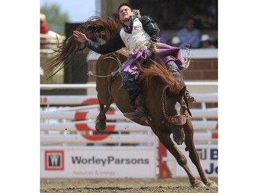 Ty Taypotat rides Rye Whiskey to a fourth place finish during day three bareback action at the 2015 Calgary Stampede, on July 5, 2015.