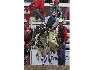 Grady Smeltzer rides his way to a first place finish during day three junior steer riding action at the 2015 Calgary Stampede, on July 5, 2015.