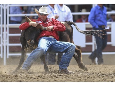 Dru Melvin finishes in seventh place during day three steer wrestling action at the 2015 Calgary Stampede, on July 5, 2015.