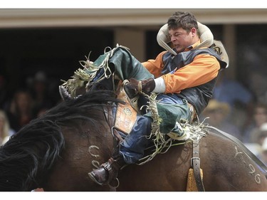 Ryley Borris rides Yoga Release to a first place finish during day three bareback novice rodeo action at the 2015 Calgary Stampede, on July 5, 2015.