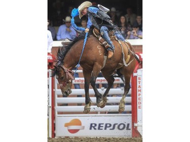 Hunter Sawley rides Yakima Warrior during day three novice saddle bronc rodeo action at the 2015 Calgary Stampede, on July 5, 2015.