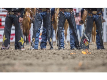Cowboys and girls are introduced in the infield as the ground in front of them is set on fire at the onset of day three rodeo action at the 2015 Calgary Stampede, on July 5, 2015.