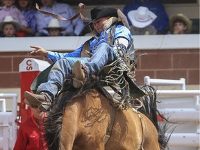 Brooks' Kyle Bowers rides his way to a first place finish during Day 3 of bareback action at the Calgary Stampede on Sunday.