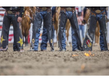 Cowboys and girls are introduced in the infield as the ground in front of them is set on fire at the onset of day three rodeo action at the 2015 Calgary Stampede, on July 5, 2015.