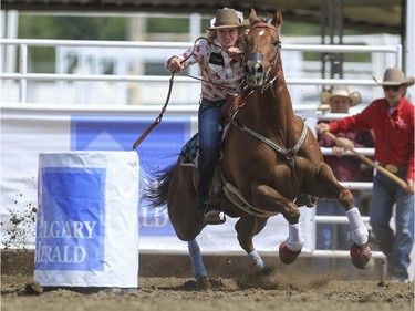 Sydney Daines speeds around the Calgary Herald barrel during day three barrel racing action at the 2015 Calgary Stampede, on July 5, 2015.