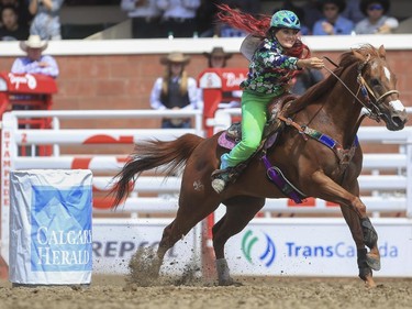 Fallon Taylor speeds around the Calgary Herald barrel during day three barrel racing action at the 2015 Calgary Stampede, on July 5, 2015.