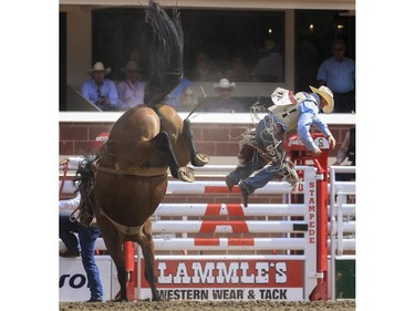 Chet Johnson gets bucked off resulting in a ninth place finish during day three saddle bronc action at the 2015 Calgary Stampede, on July 5, 2015.