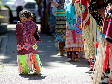 Aliannah White Eagle from the Siksika Nation waits to perform in the fancy dress dance at Olympic Plaza during the Calgary Stampede on July 6.