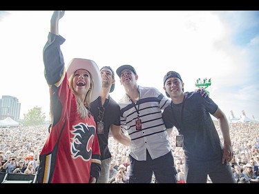 Miss America, Kira Kazantsev, takes a selfie with Calgary Flames players Josh Jooris, Sean Monahan, and Johnny Gaudreau in front of a crowd of thousands at the Calgary Stampede Roundup at Fort Calgary in Calgary on Wednesday, July 8, 2015.