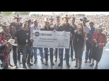 Stampede Roundup presents a cheque for $225,000 to the Rotary Club prior to Journey playing at the Calgary Stampede Roundup at Fort Calgary in Calgary on Wednesday, July 8, 2015.