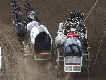 Ray Mitsuing, left, and Wayne Knight come close to colliding in heat three, day nine, of the GMC GMC Rangeland Derby at the Calgary Stampede Grandstand in Calgary on Saturday, July 11, 2015.