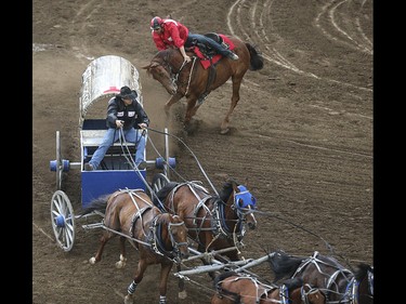 Layne MacGillivray, left, cuts off Quaid Tournier during heat four, day nine, of the GMC GMC Rangeland Derby at the Calgary Stampede Grandstand in Calgary on Saturday, July 11, 2015.