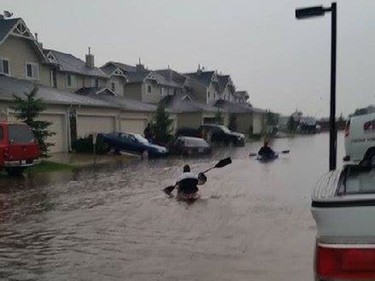 Residents in Langdon making due in their canoes. Photo by Launa Austin.