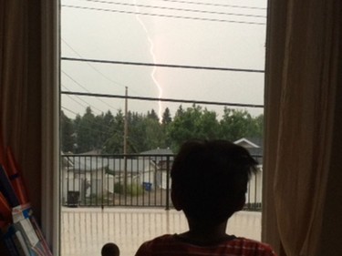 A four-year-old storm watcher observes the lightning.