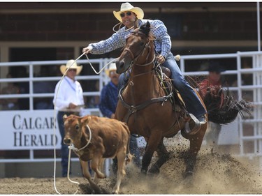 Randall Carlisle ropes his way to a fourth place finish during Day 9 of tie-down roping action at the 2015 Calgary Stampede,, on July 11, 2015.