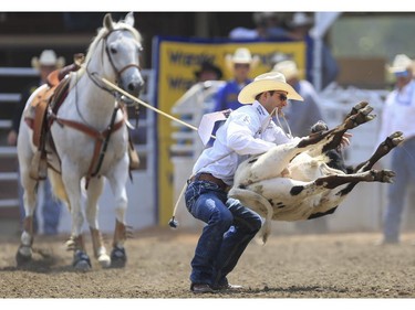 Shane Hanchey finish with third place for Day 9 of tie-down roping action at the 2015 Calgary Stampede,, on July 11, 2015.