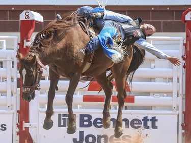 Colin Adams is barely hanging on to the infamous Rye Whyskey and finishes in ninth during Day 9 of bareback rodeo action at the 2015 Calgary Stampede,, on July 11, 2015.