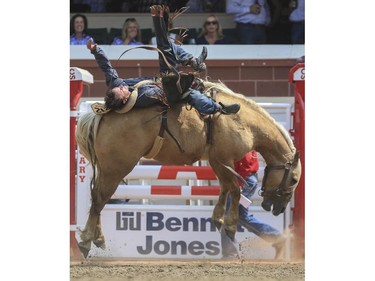 Will Lowe lays it all out as he rides Gold Dust to a second place finish during Day 9 of bareback rodeo action at the 2015 Calgary Stampede,, on July 11, 2015.