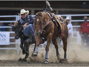 Dakota Eldridge made looked pretty as he tackled his steer for a ninth place finish during Day 9 of steer wrestling rodeo action at the 2015 Calgary Stampede,, on July 11, 2015.