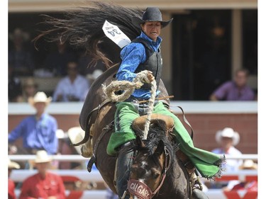 Kole Ashbacher rides Uncut Diamond during day 9 of novice saddle bronc action at the 2015 Calgary Stampede,, on July 11, 2015.