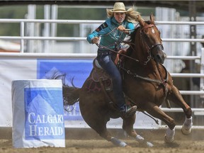 Sydney Daines races around barrel three for the quickest time during Day 9 of barrel racing action at the 2015 Calgary Stampede.