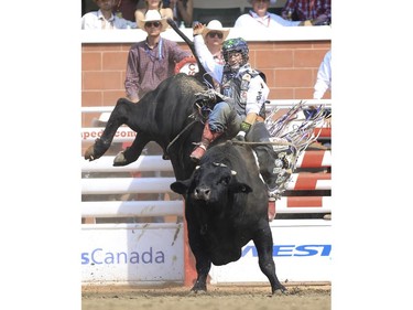 Cody Nance rides Man In Black  during Day 9 of bull riding rodeo action at the 2015 Calgary Stampede, on July 11, 2015.