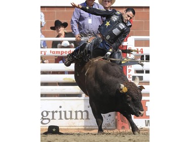 Joao Ricardo Vieira of Brazil rides Wonder Boy to a second place finish during Day 9 of bull riding rodeo action at the 2015 Calgary Stampede, on July 11, 2015.