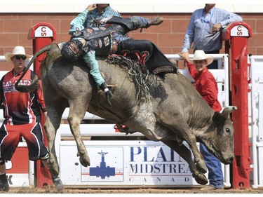 Chandler Bownds rides Chuckey to a first place during Day 9 of bull riding rodeo action at the 2015 Calgary Stampede, on July 11, 2015.
