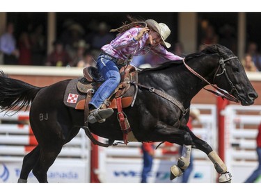 Kassidy Dennison race to the finish line during day 9 of barrel racing action at the 2015 Calgary Stampede, on July 11, 2015.