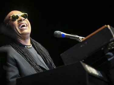 Stevie Wonder throws his head back and laughs as he plays the piano during the last Saddledome concert performance of the 2015 Calgary Stampede in Calgary, on July 12, 2015.