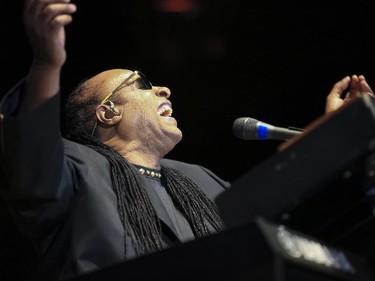 Stevie Wonder throws his hands up as he finish his first song during the last Saddledome concert performance of the 2015 Calgary Stampede in Calgary, on July 12, 2015.