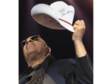 Stevie Wonder holds up a white cowboy hat that he signed during last Saddledome concert performance of the 2015 Calgary Stampede in Calgary, on July 12, 2015. Wonder tossed the signed hat out to the crowd.