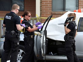 Calgary police investigate a shooting that sent one man to hospital with critical injuries and left one man dead in Calgary's N.E. along Rundlehorn Drive on July 11, 2015.