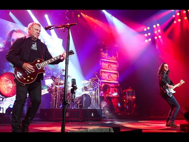 Alex Lifeson, left, Neil Peart, and Geddy Lee entertain Rush fans at the Scotiabank Saddledome in Calgary on Wednesday, July 15, 2015.