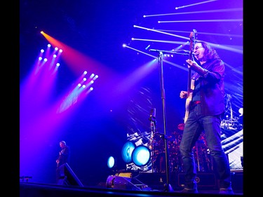 Alex Lifeson, left, Neil Peart, and Geddy Lee entertain Rush fans at the Scotiabank Saddledome in Calgary on Wednesday, July 15, 2015.