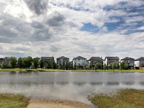 Storm waters sit in the storm ponds behind Prairie Waters and St. Gabriel Schools on July 15, 2015 following the storm waters which flooded homes in Chestermere.