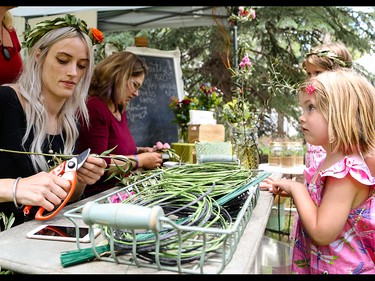 Geneva Haley, left, prepares a olive wreath while Sophie Trudeau looks on, at Folk Fest on Prince's Island Park in Calgary on Thursday, July 23, 2015.