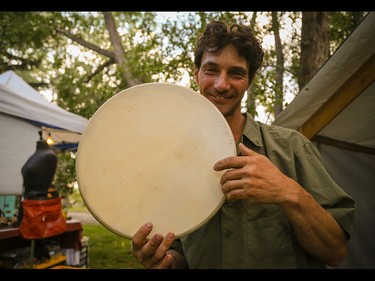 Robin Shackelton drums up some business at his booth, Sylvan Temple World Instruments, at Folk Fest on Prince's Island Park in Calgary on Thursday, July 23, 2015.