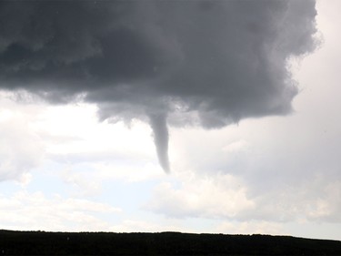 A possible funnel cloud slips down from a cloud south of Discovery Ridge in Calgary on July 22, 2015. The City of Calgary was put under a tornado watch around 1 p.m.