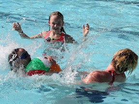 Sheri Young with Sydney Wurzer, 6, and Ashleigh Wurzer, 9, enjoy the reprieve that the water at the South Calgary Pool in Calgary gives, on July 21, 2015.