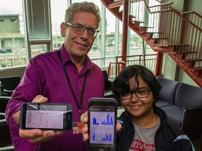 Prof. Mike Smith, left, and Orchisama Das present an Android app designed to help identify and locate the source of mysterious hums in the community of Ranchlands, at the University of Calgary on Monday, July 27, 2015.