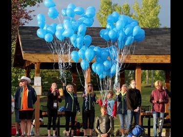 Balloons are released during a moment of silence for the little boy who drowned in Auburn Bay before athletes compete in the Ironman 70.3 Calgary on July 26, 2015.