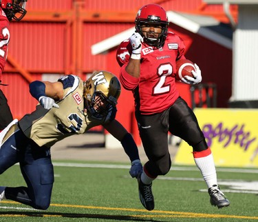 Calgary Stampeders Tim Brown, right, evades Winnipeg Blue Bombers Graig Newman during their game at McMahon Stadium on July 18, 2015.