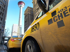 Colleen De Neve/ Calgary Herald CALGARY, AB --DECEMBER 4, 2014 -- Taxi's line up on 9th Avenue across from the Palliser Hotel as they wait for fares on December 4, 2014. (Colleen De Neve/Calgary Herald) (For City story by Eva Ferguson) 00061000A SLUG: 1205-Taxis